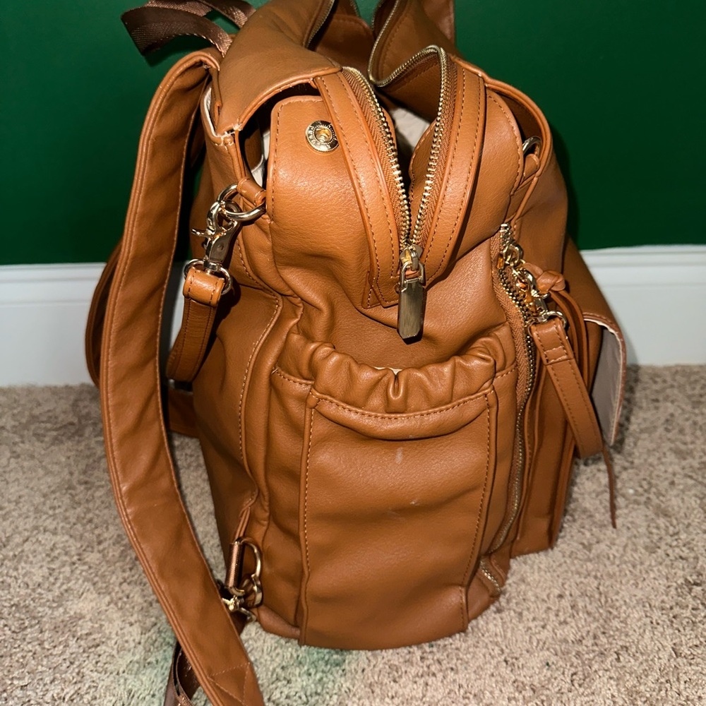 Large diaper bag with insulated compartments for bottles. Includes changing pad.